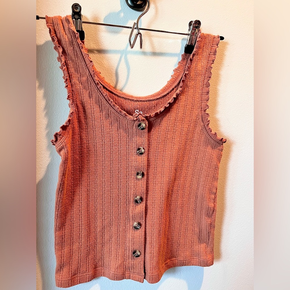 Tank top with buttons down the middle.